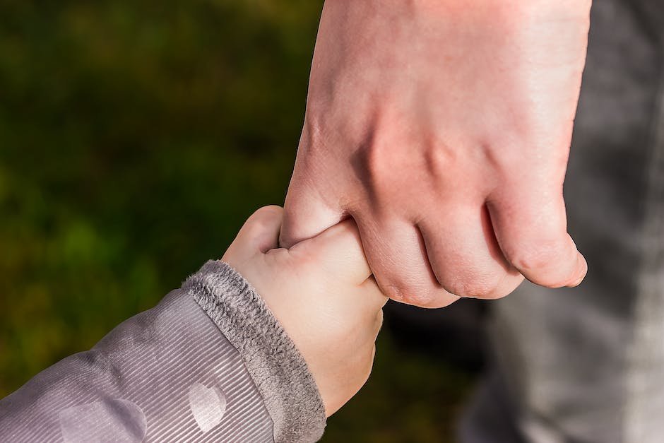 Image depicting a parent and child holding hands, symbolizing a strong bond of communication and understanding