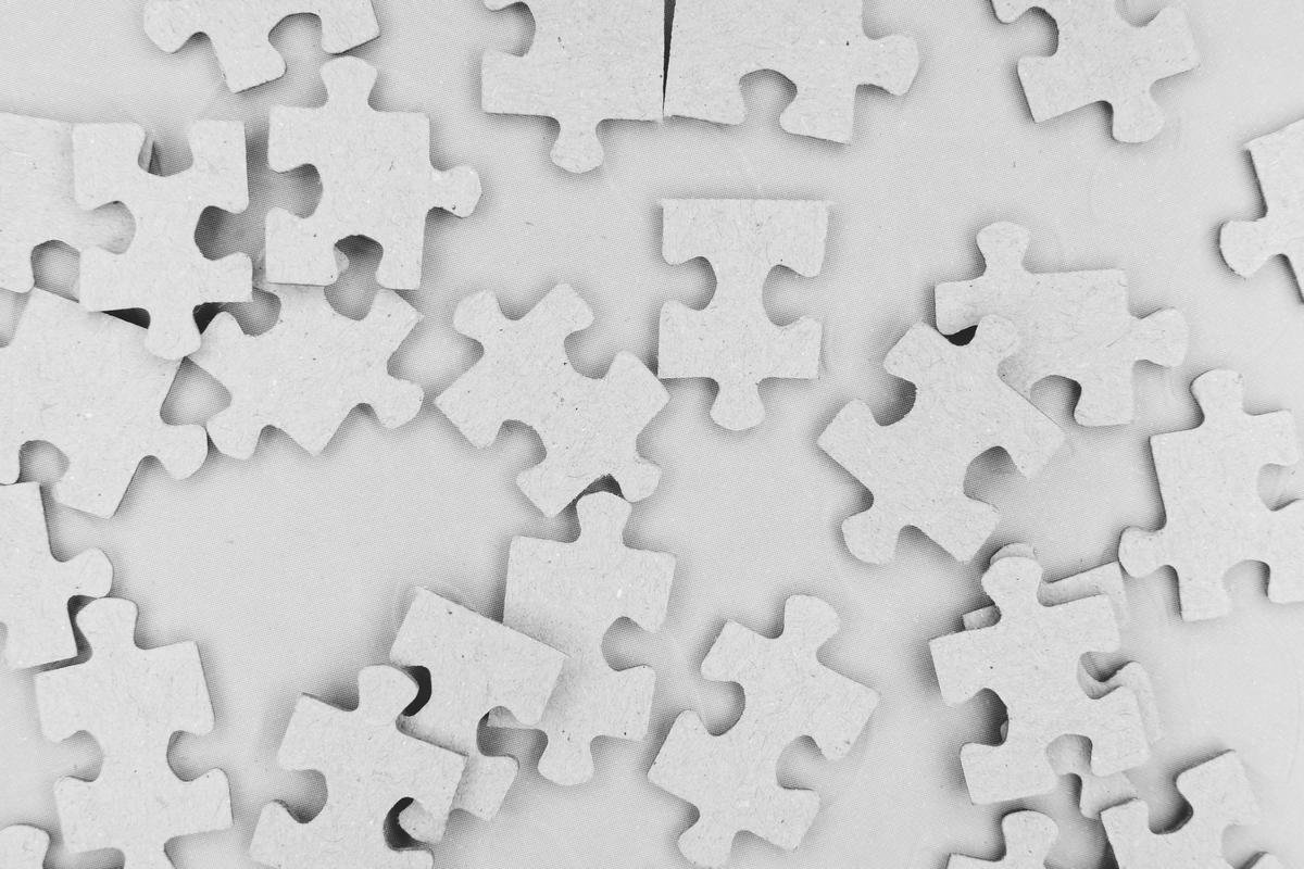 Image description: Illustration depicting a child holding a puzzle piece, symbolizing progress for autistic children in CBT.