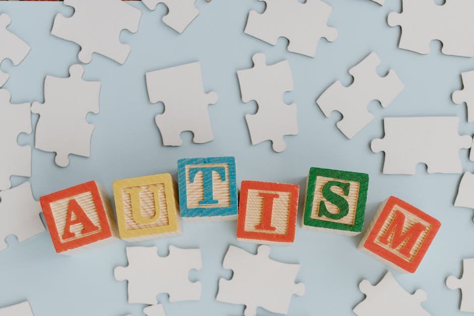 Illustration of a child with autism, surrounded by puzzle pieces, symbolizing the complexity and uniqueness of their condition.