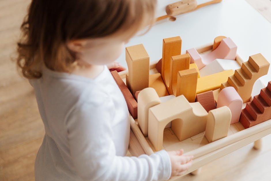 An image showing a child with autism engaging in sensory activities, such as touching different textures and exploring objects.