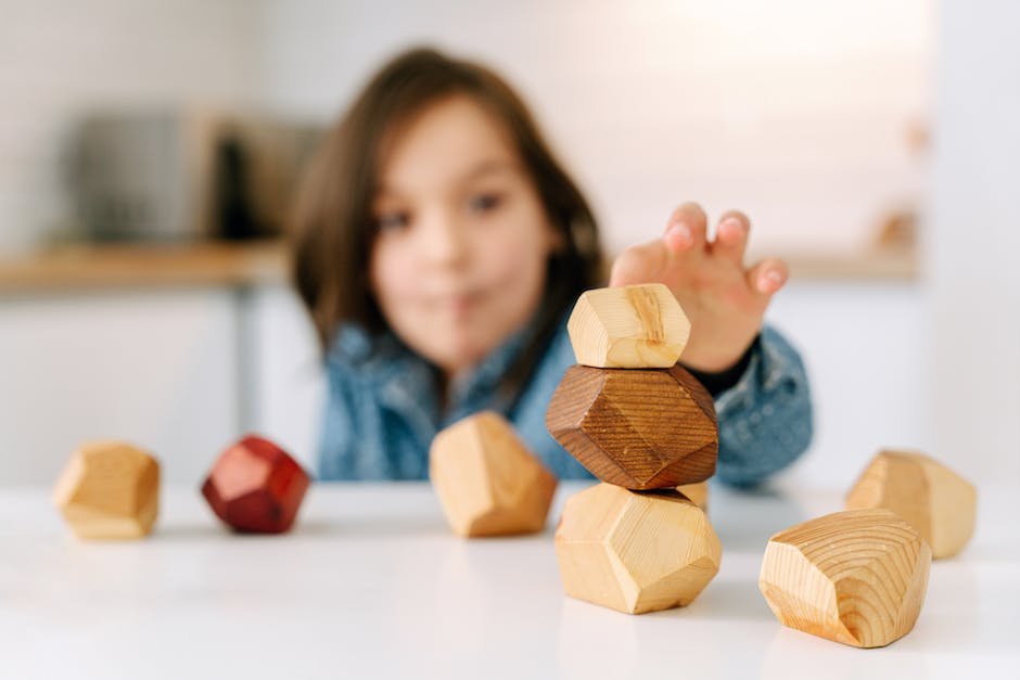A child with autism stacking blocks, demonstrating the importance of routines and structures in their safety.