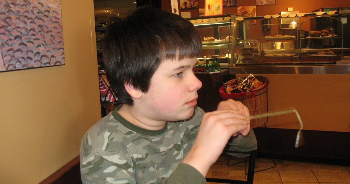 An autistic student uses stimming behaviors to maintain focus and cope with sensory challenges in a classroom setting, highlighting the need for understanding and accommodation in educational environments.