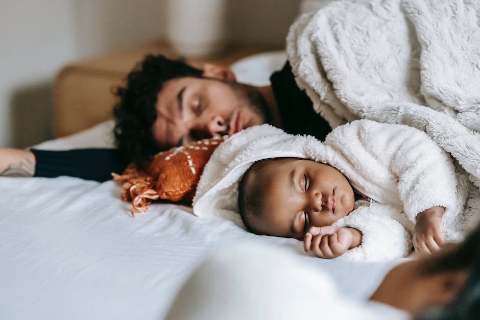 Image of a parent and child sleeping peacefully together