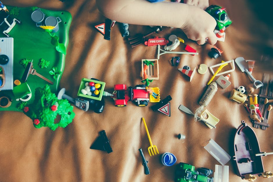 A picture of a child with his toys spread around him, representing hoarding behavior in autistic children.