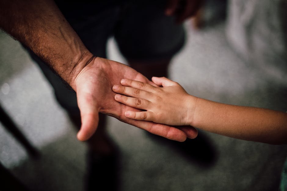 A parent and child holding hands and looking at each other, communicating silently