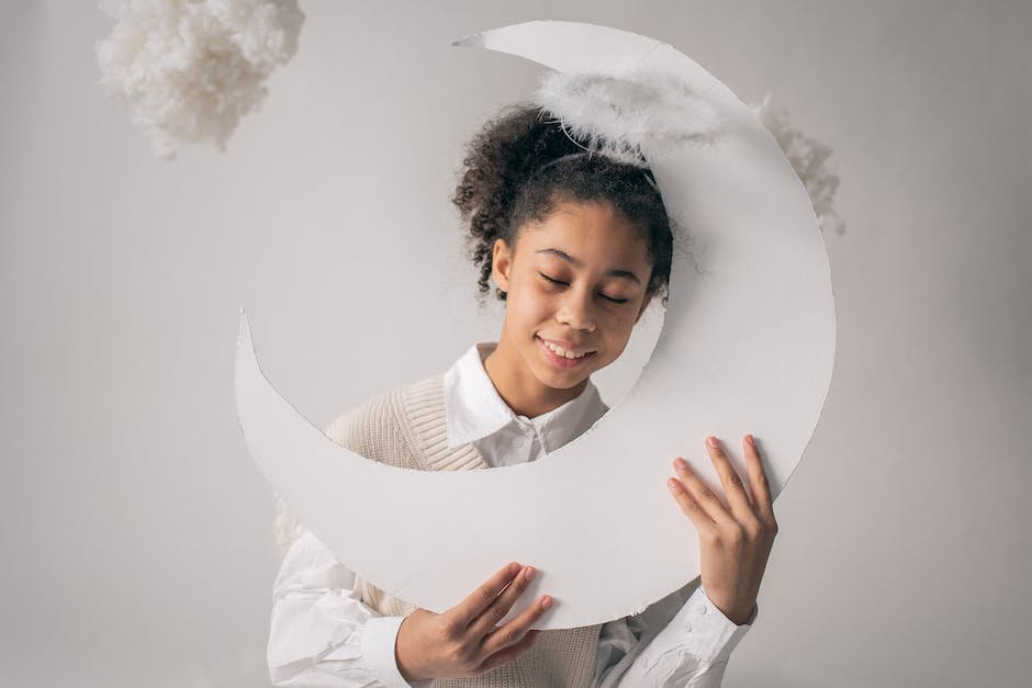 An image of a peaceful sleeping child with moon and stars in the background.