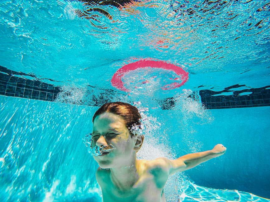 Image illustrating a child with autism swimming happily in a pool, experiencing the therapeutic benefits of swimming.