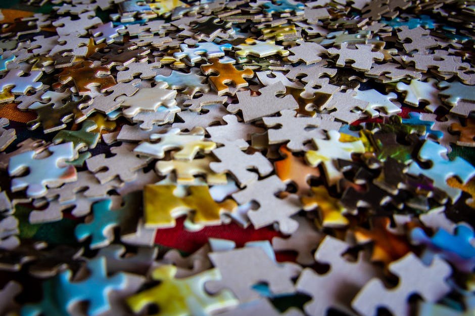 Image depicting a child holding a bottle of Vitamin D supplements with a background of colorful puzzle pieces, symbolizing Autism Spectrum Disorder.