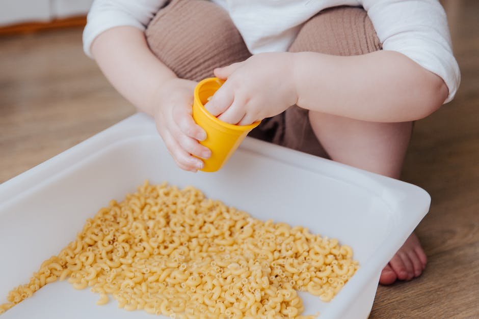 An image of a child with autism engaging in sensory-friendly activities, wearing soft clothing and using a sensory bin.