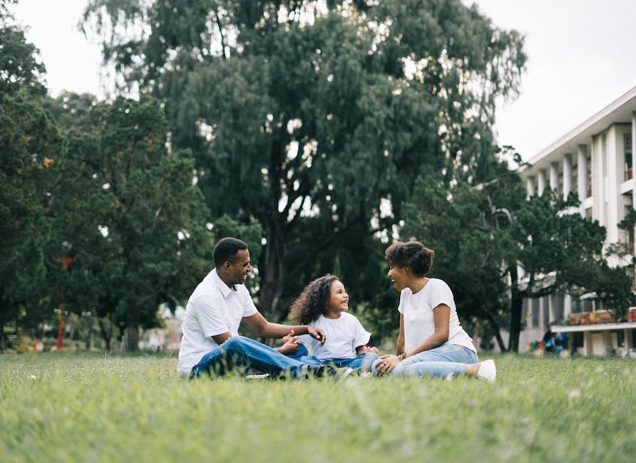 Illustration of a family holding hands, with a child on the autism spectrum in the center, surrounded by colorful puzzle pieces to represent diversity and understanding.