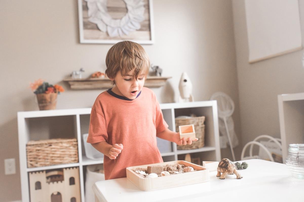 Image depicting a child playing and exploring with colorful toys and art supplies in a calm and supportive environment