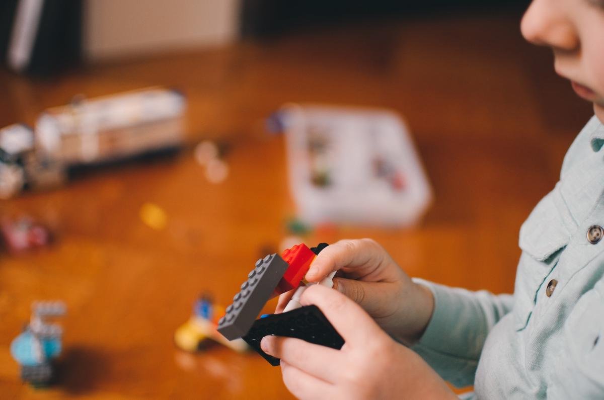 An image of a young child with autism playing with colorful blocks