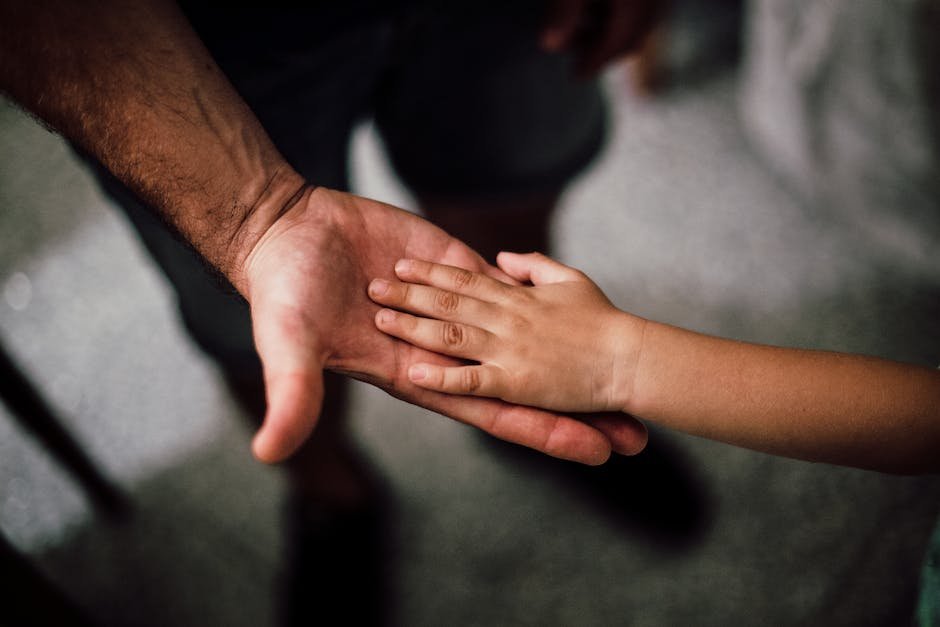 An image of a parent and child holding hands, symbolizing the vital role of vaccines in protecting children's health.